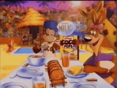 Two Cartoon Characters Sitting At Table With Kellogg's Coco Pops GIF