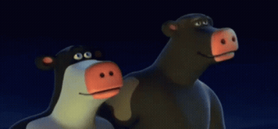 Two Cartoon Cows With Red Noses In The Dark GIF