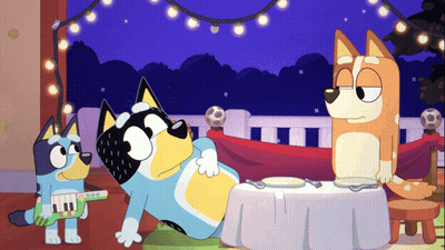 Two Cartoon Dogs Sitting At Table GIF