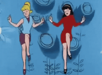 Two Cartoon Girls Are Dancing In Front Of A Blue Wall With Circles On It . GIF