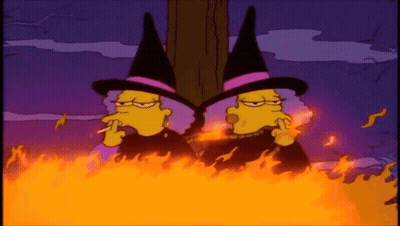 Two Cartoon Witches Smoking Cigarettes In Bonfire GIF