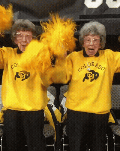 Two Cheerleaders In Yellow Sweaters Saying Colorado GIF