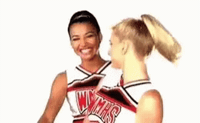 Two Cheerleaders Talking And Smiling GIF