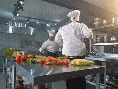 Two Chefs Cooking With Vegetables GIF