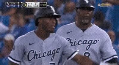 Two Chicago Baseball Players Are Talking To Each Other On The Field GIF