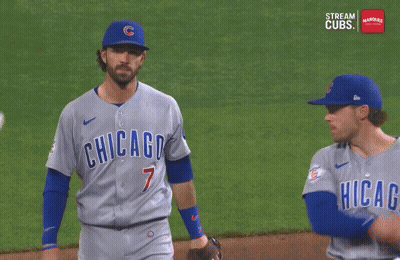 Two Chicago Cubs Baseball Players Are Talking To Each Other On The Field GIF