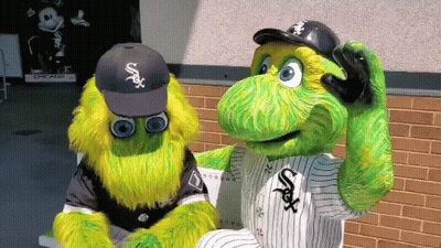 Two Chicago White Sox Mascots Are Sitting On A Bench In Front Of A Brick Wall GIF