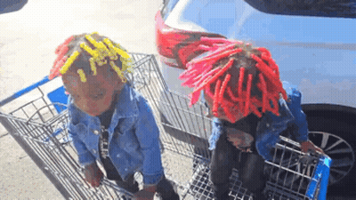 Two Children In Red Dreadlocks Pushing Shopping Cart GIF