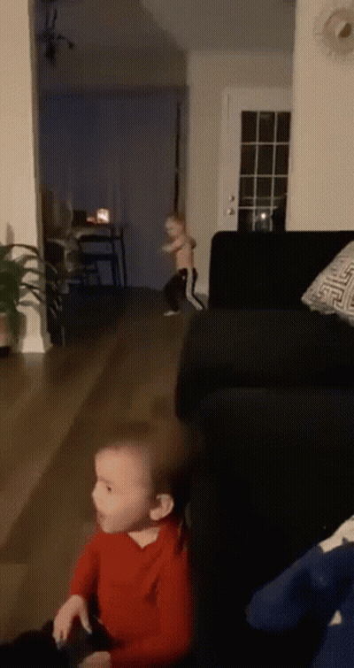 Two Children Playing In Living Room With Couch And Table GIF