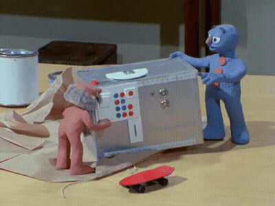 Two Clay Figures Beside Safe And Skateboard GIF