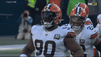 Two Cleveland Browns Players Number 90 And 32 GIF