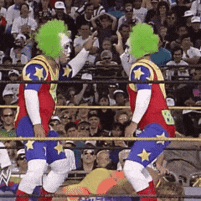 Two Clowns In A Wrestling Ring With The Number 8 On Their Backs GIF