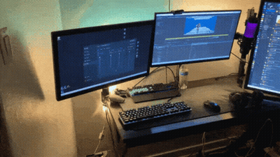 Two Computer Monitors Are Sitting On A Desk With A Keyboard GIF