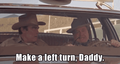 Two Cowboy Hat Men Saying Make Left Turn Driving GIF