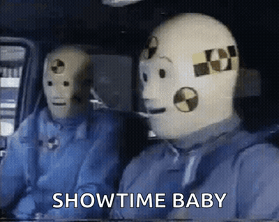 Two Crash Test Dummies In Car Saying Showtime Baby GIF