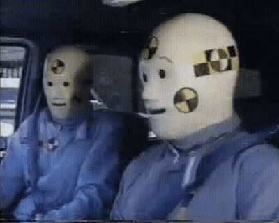 Two Crash Test Dummies Sitting In A Car GIF