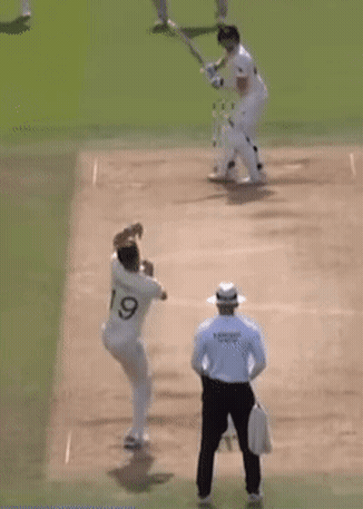 Two Cricket Players Are Playing A Game Of Cricket On A Field With A Referee Watching . GIF