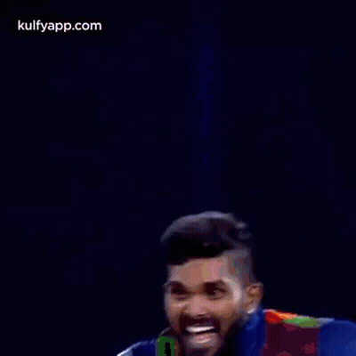 Two Cricket Players Are Standing Next To Each Other And Celebrating A Victory . GIF
