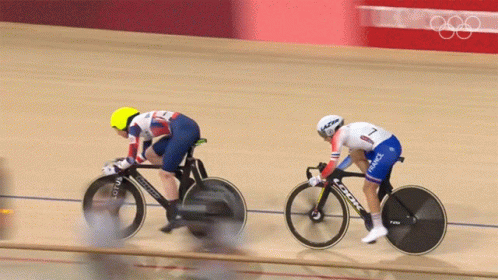 Two Cyclists Are Racing On A Track And One Is Wearing A France Uniform GIF