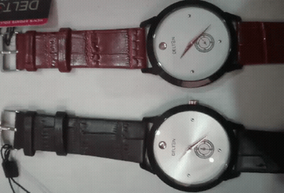 Two Delta Watches Are Sitting On A White Surface GIF