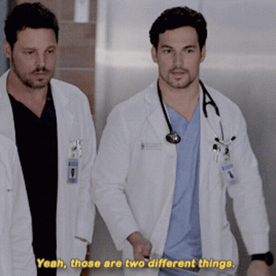 Two Doctors Walking Down Hallway Saying Yeah Those Are Two Different Things GIF