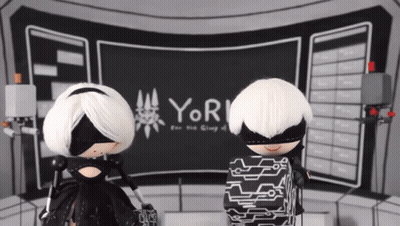 Two Dolls In Front Of Screen Saying Yor GIF