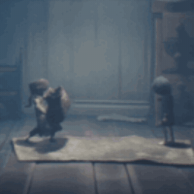 Two Dolls Standing On Rug In Dark Room GIF