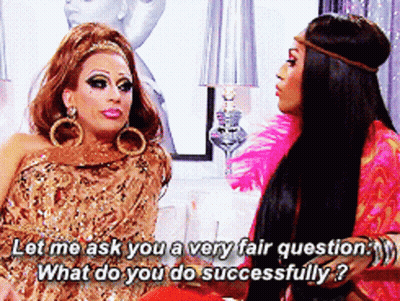 Two Drag Queens Are Sitting Next To Each Other And One Of Them Is Asking The Other What She Does Successfully GIF