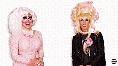 Two Drag Queens Are Standing Next To Each Other With The Word Doctor Behind Them GIF