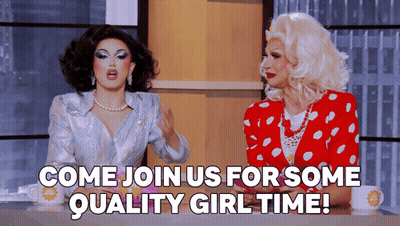 Two Drag Queens Sitting At Table Saying Come Join Us For Quality Girl Time GIF