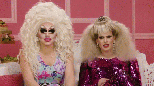 Two Drag Queens Sitting On Couch GIF