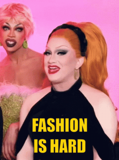 Two Drag Queens Standing Together Saying Fashion Is Hard GIF