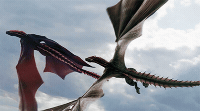 Two Dragons Flying In The Sky With Their Wings Outstretched GIF