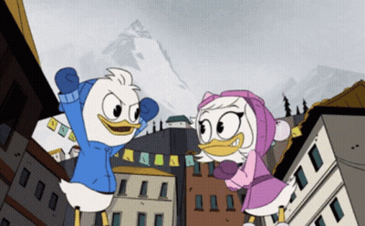 Two Ducks Standing In Front Of Buildings GIF
