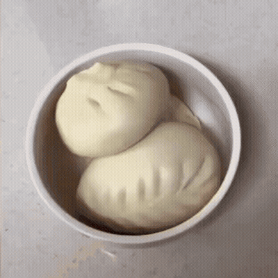 Two Dumplings In A Bowl That Looks Like A Person 'S Face GIF