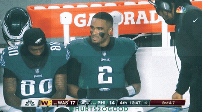 Two Eagles Players On Sidelines With Gatorade Cooler GIF