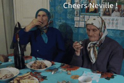 Two Elderly Women Sit At A Table With The Words Cheers Neville GIF