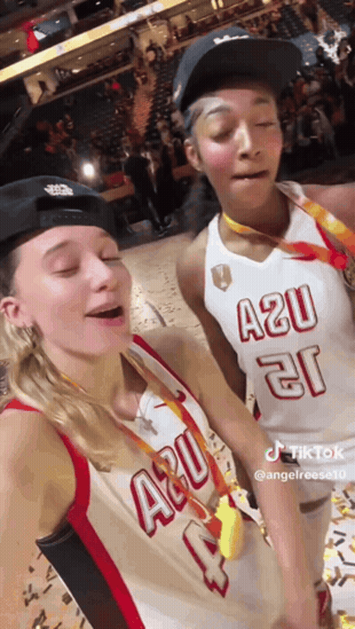 Two Female Basketball Players Posing On Court GIF