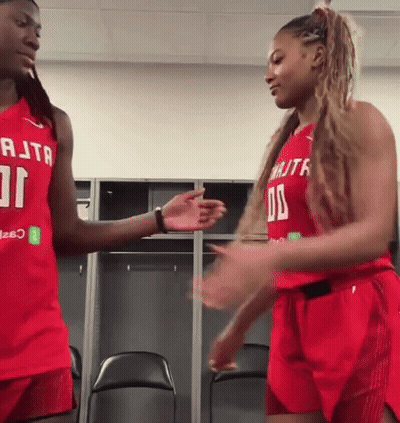 Two Female Basketball Players Shaking Hands In Red RTA Jerseys GIF