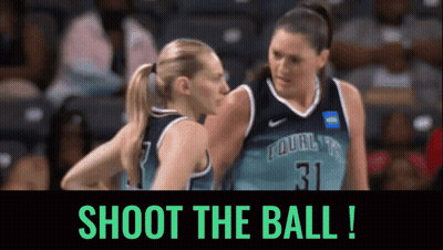 Two Female Basketball Players Shoot the Ball