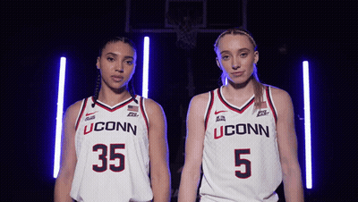Two Female Basketball Players Wearing Uconn Uniforms Stand Next To Each Other GIF