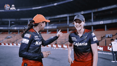 Two Female Cricket Players Wearing Shirts That Say Kajaria On Them GIF