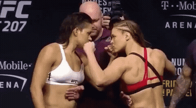Two Female Fighters Next To T Mobile Sign GIF