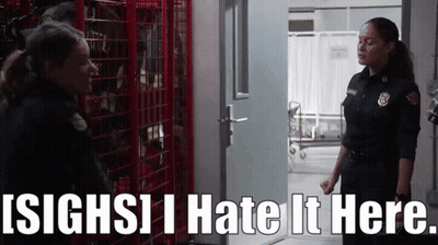 Two Female Firefighters Standing Next To Each Other With The Words ' Sighs I Hate It Here ' Above Them GIF