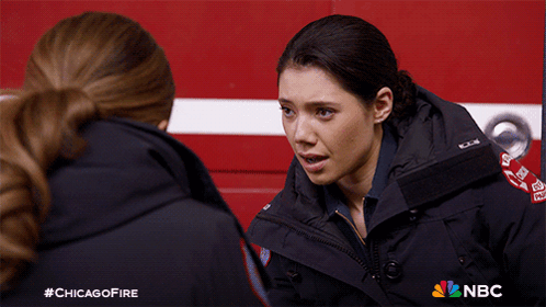 Two Female Firefighters Talking In Front Of Fire Truck With NBC Logo GIF