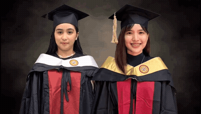 Two Female Graduates Standing GIF