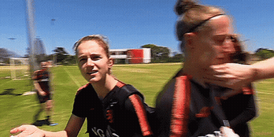 Two Female Soccer Players Holding Face GIF