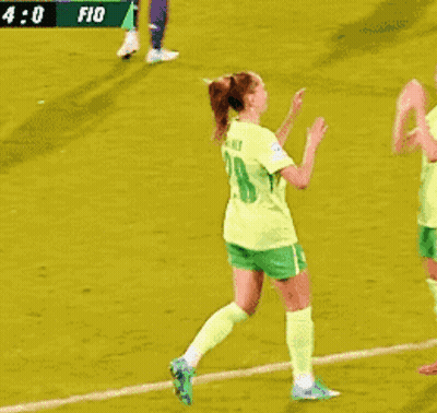 Two Female Soccer Players In Green Shorts And Yellow Jerseys Number 21 GIF