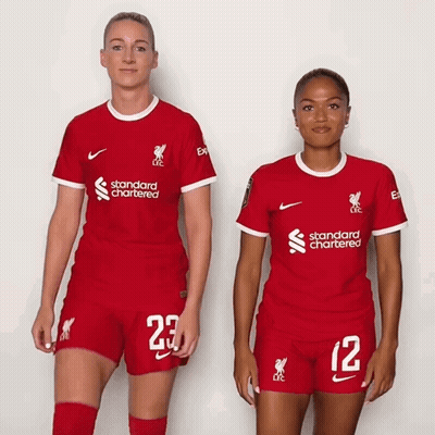 Two Female Soccer Players In Red Standard Chartered Uniforms GIF