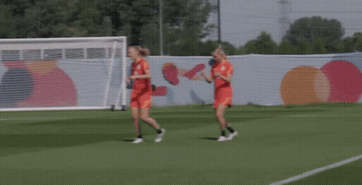 Two Female Soccer Players Running On A Field GIF